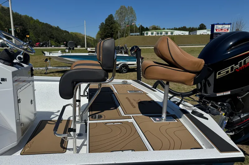 Slide: The Image of 2026 Xpress XR21 Bay boat with tan seating and powerful outboard motor. - 8
