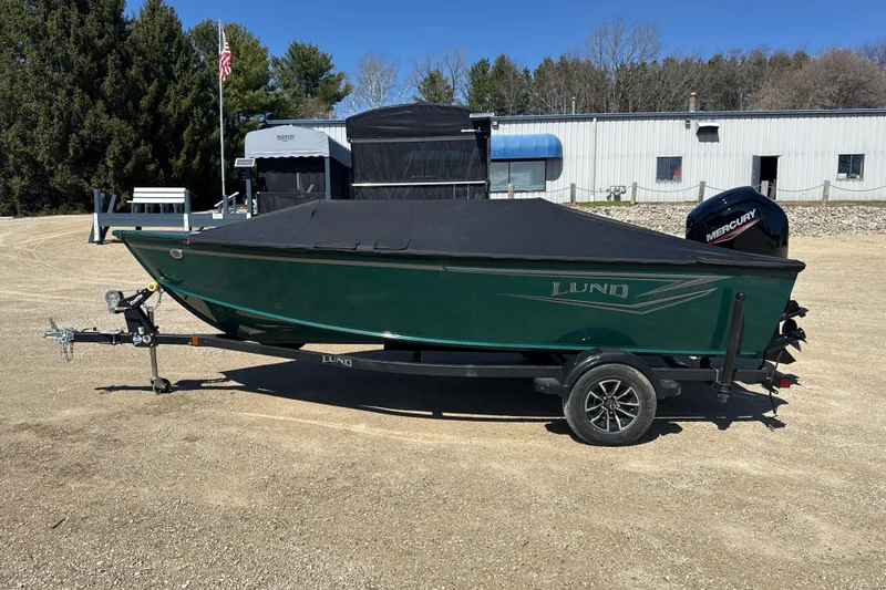 Slide: The Image of 2026 Lund 1700 Explorer SS boat on trailer, covered, with Mercury outboard motor. - 10