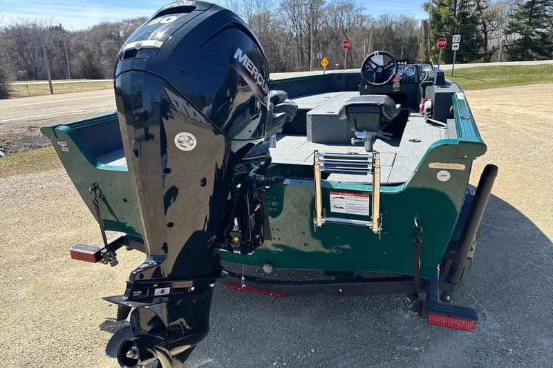 Slide: The Image of 2026 Lund 1700 Explorer SS boat with Mercury outboard motor, parked on gravel. - 3