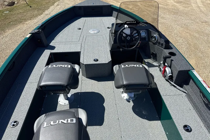Slide: The Image of 2026 Lund 1700 Explorer SS boat interior with two seats and steering console. - 4