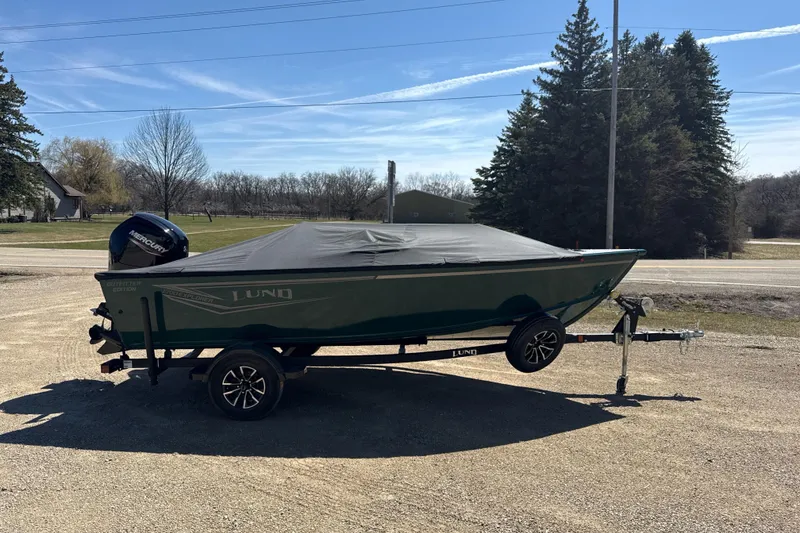 Slide: The Image of 2026 Lund 1700 Explorer SS boat on trailer, covered, parked outdoors. - 9