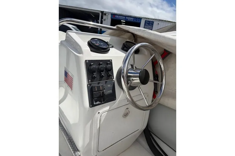 Slide: The Image of Steering console of a 2010 Nautica RIB 14 boat with control panel. - 3