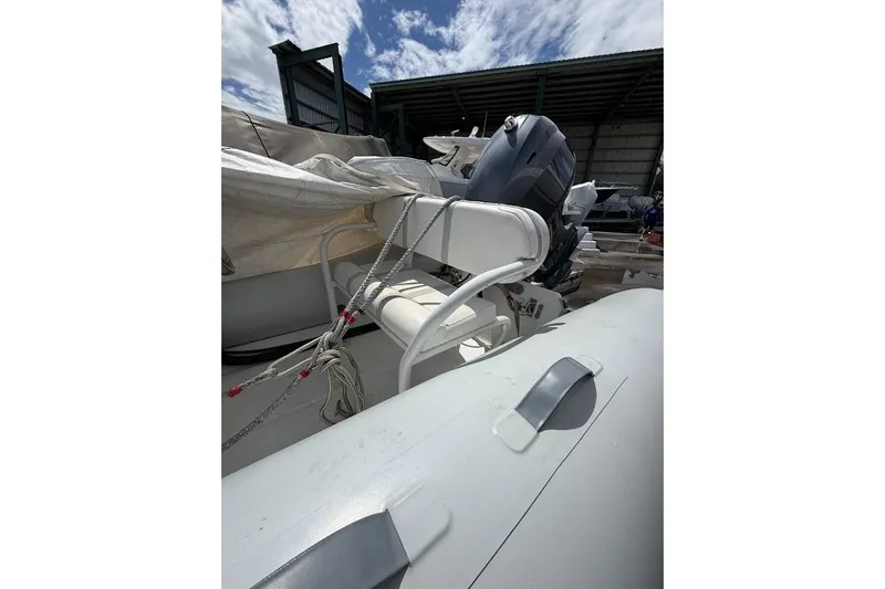 Slide: The Image of 2010 Nautica RIB 14 inflatable boat with outboard motor in storage. - 8