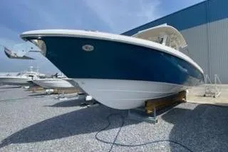 The Image of 2019 Everglades 335 Center Console boat displayed outdoors near a warehouse. - 1