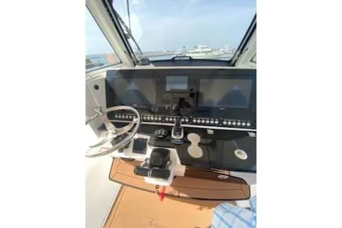 Slide: The Image of 2019 Everglades 335 Center Console boat dashboard with modern controls and navigation equipment. - 10