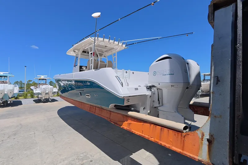 Slide: The Image of 2019 Everglades 335 Center Console boat with Yamaha engines on a lift. - 12
