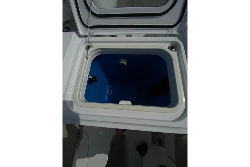 Slide: The Image of Open storage compartment on 2019 Everglades 335 Center Console boat. - 14