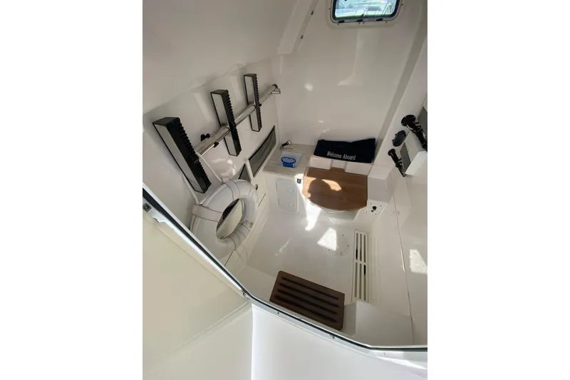 Slide: The Image of Interior of 2019 Everglades 335 Center Console boat, featuring a compact, well-equipped cabin. - 15