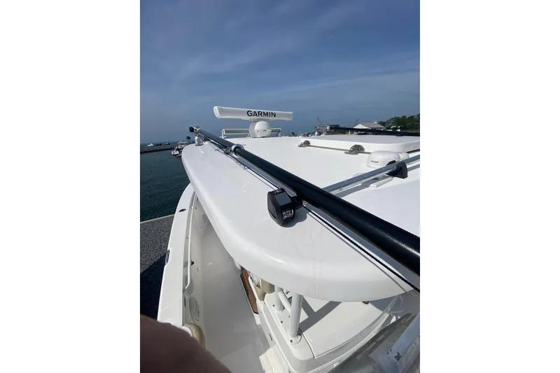 Slide: The Image of 2019 Everglades 335 Center Console boat with Garmin radar, docked by the sea. - 17