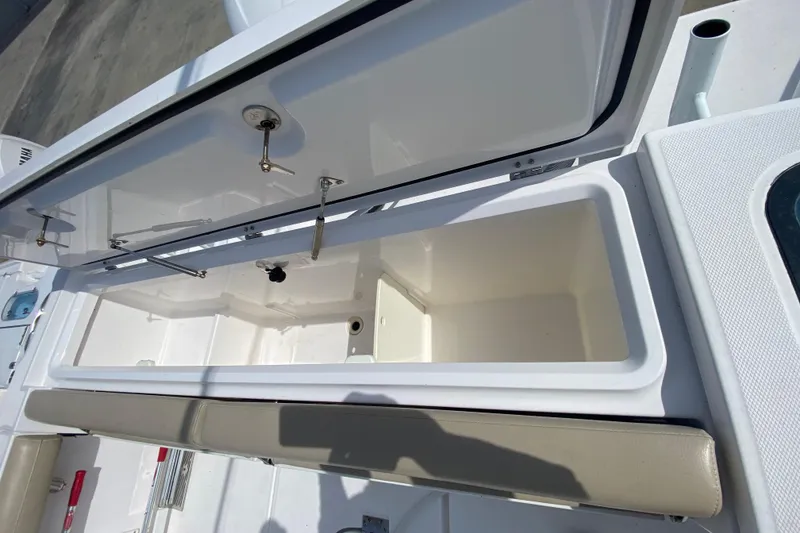 Slide: The Image of Open storage compartment on a 2019 Everglades 335 Center Console boat. - 18
