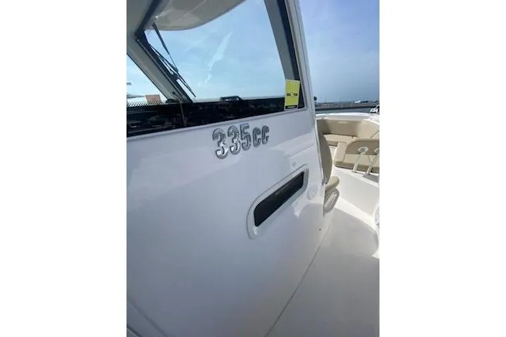 Slide: The Image of 2019 Everglades 335 Center Console boat displayed outdoors on gravel. - 4