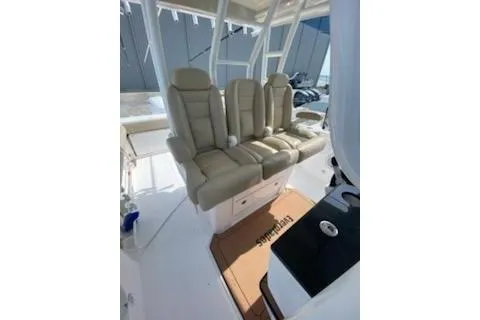 Slide: The Image of 2019 Everglades 335 Center Console boat, showcasing sleek design and spacious seating. - 5