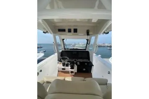 Slide: The Image of 2019 Everglades 335 Center Console boat with tan seating and Garmin equipment. - 8