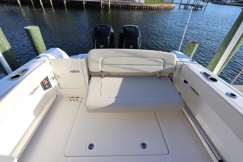 Slide: The Image of 2016 Boston Whaler 270 Vantage boat interior with seating and twin engines. - 11