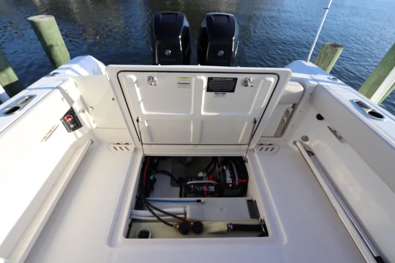 Slide: The Image of Boston Whaler 270 Vantage 2016 boat engine compartment with open hatch, dockside view. - 12