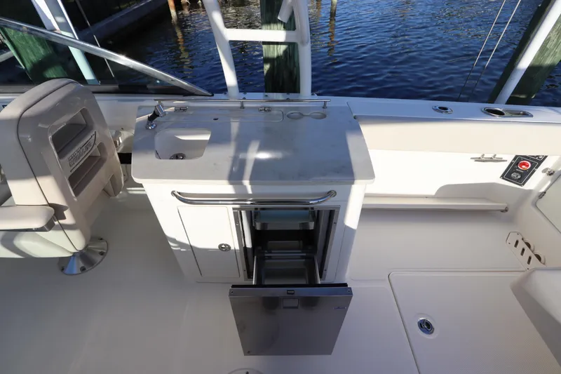 Slide: The Image of 2016 Boston Whaler 270 Vantage boat interior with sink and storage area. - 19
