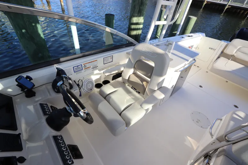Slide: The Image of 2016 Boston Whaler 270 Vantage boat interior with helm, seating, and water view. - 20