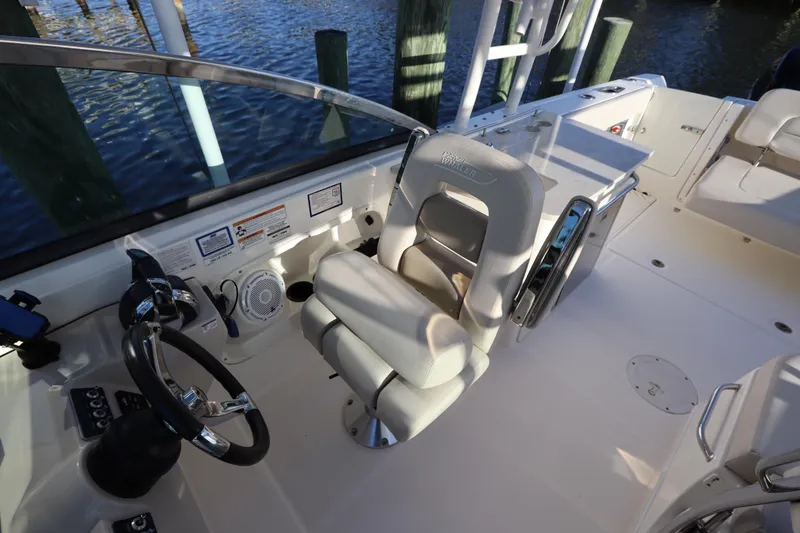 Slide: The Image of 2016 Boston Whaler 270 Vantage boat interior with helm and seating area. - 21