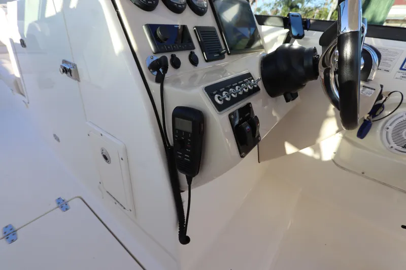 Slide: The Image of Control panel of a 2016 Boston Whaler 270 Vantage boat with steering wheel and instruments. - 25