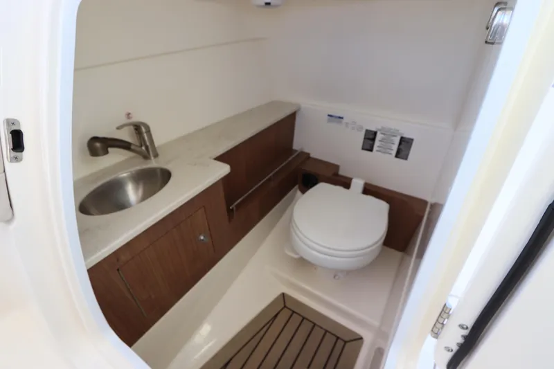 Slide: The Image of 2016 Boston Whaler 270 Vantage boat interior with sink and toilet. - 27