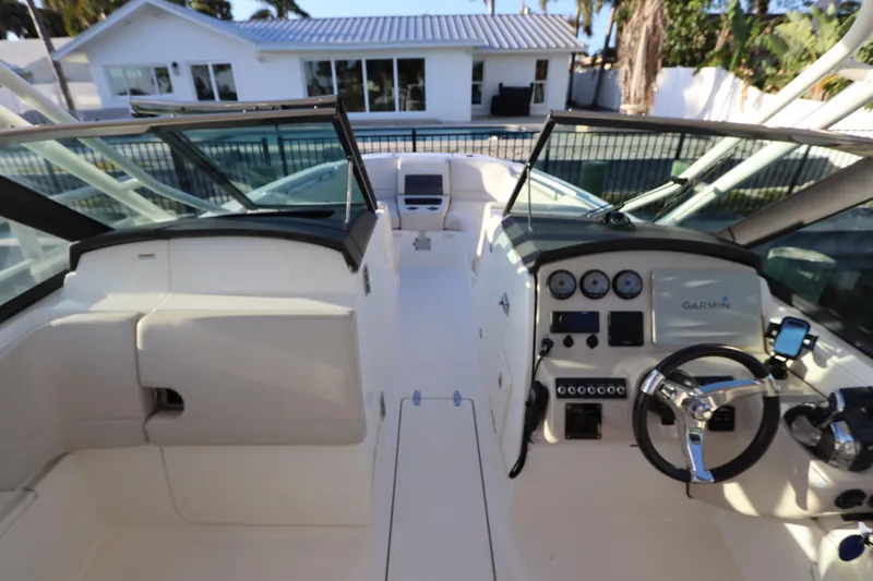 Slide: The Image of 2016 Boston Whaler 270 Vantage boat cockpit with steering wheel and navigation instruments. - 29