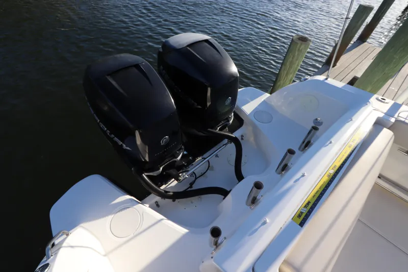 Slide: The Image of 2016 Boston Whaler 270 Vantage boat with dual Mercury outboard engines docked by water. - 3
