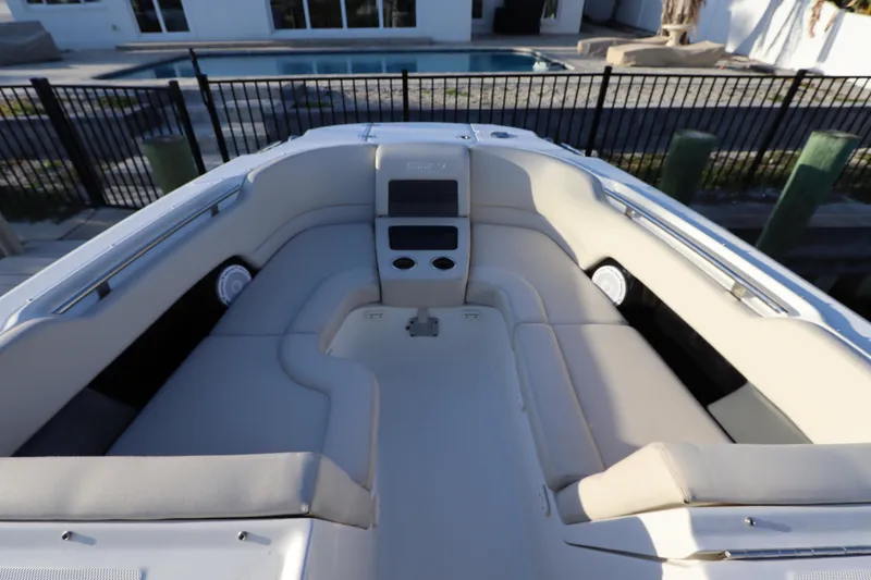 Slide: The Image of 2016 Boston Whaler 270 Vantage boat interior with cushioned seating and cup holders. - 30