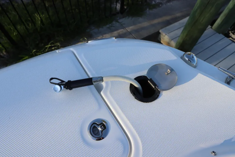 Slide: The Image of Fuel cap and hose on 2016 Boston Whaler 270 Vantage boat deck. - 31
