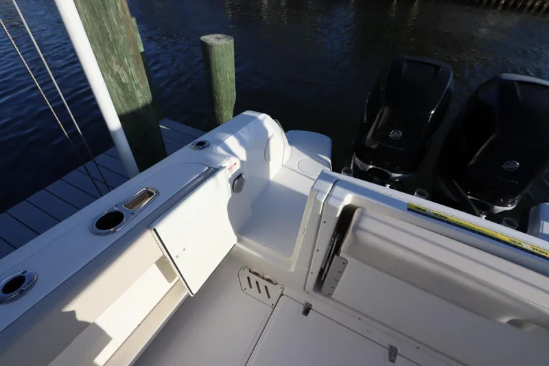 Slide: The Image of 2016 Boston Whaler 270 Vantage boat with dual outboard engines at dock. - 6