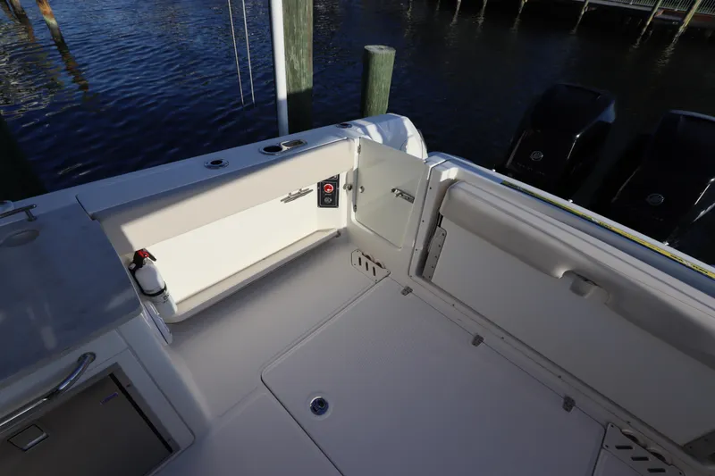 Slide: The Image of 2016 Boston Whaler 270 Vantage boat interior with open deck and dual engines. - 8