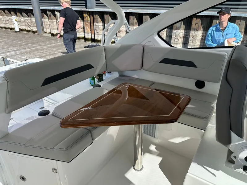 Slide: The Image of Interior of 2024 Pursuit OS405 with elegant seating and wooden table. - 11