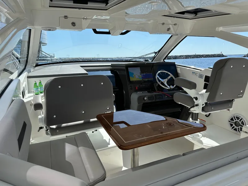 Slide: The Image of Interior of 2024 Pursuit OS405 yacht with modern cockpit and seating area. - 13