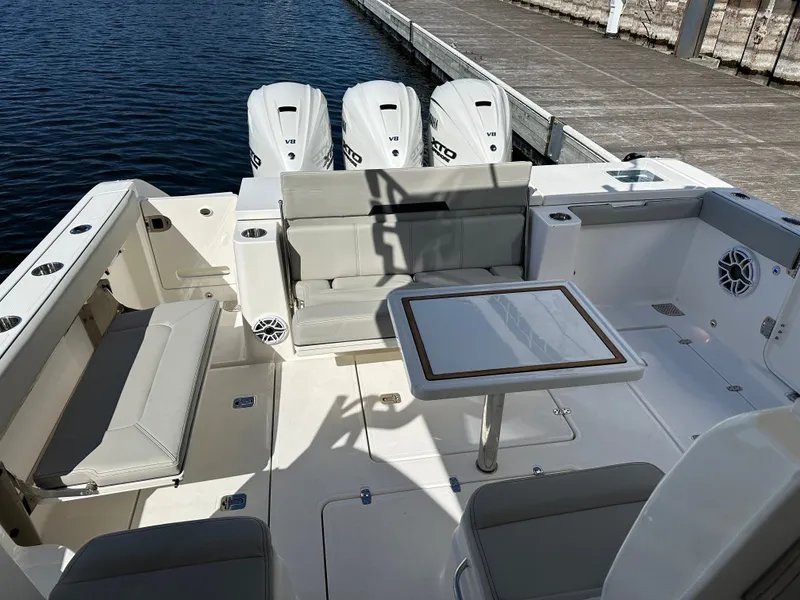 Slide: The Image of Interior view of 2024 Pursuit OS405 yacht with seating area and table. - 15