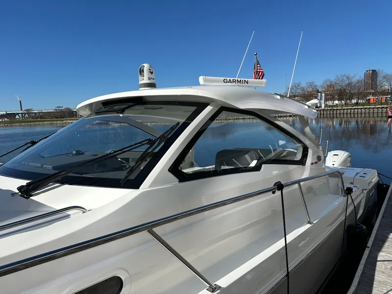 Slide: The Image of 2024 Pursuit OS405 boat docked under clear blue sky. - 2
