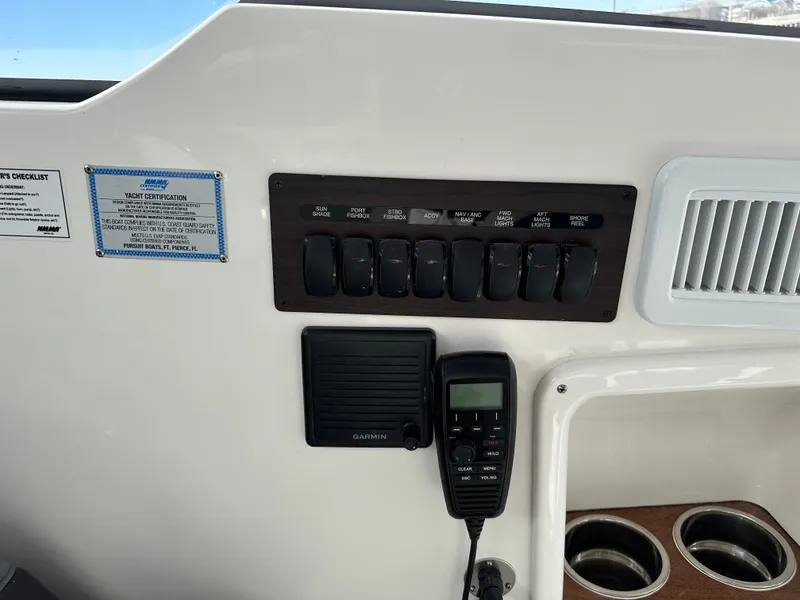 Slide: The Image of Control panel of 2024 Pursuit OS405 with switches and radio. - 7