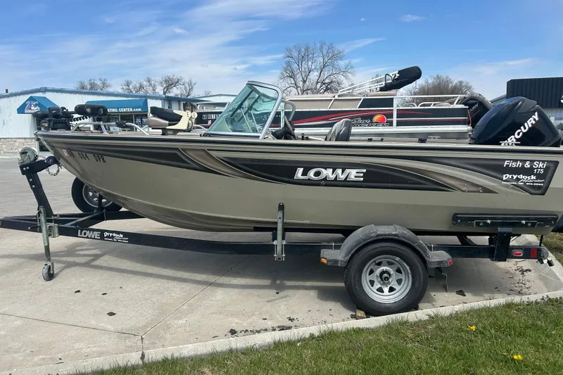 The Image of 2006 Lowe Fish & Ski 175 boat on trailer, parked outdoors under clear sky. - 0