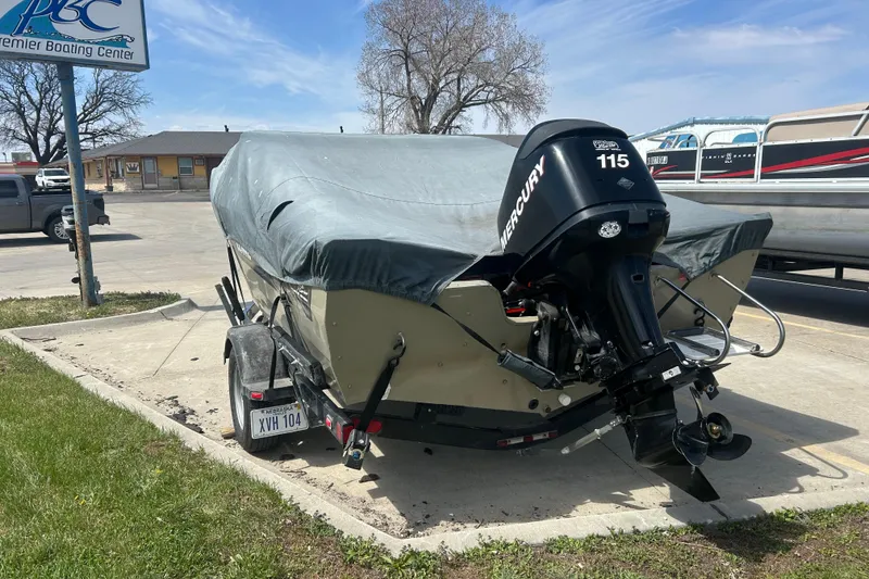 Slide: The Image of 2006 Lowe Fish & Ski 175 boat with Mercury 115 engine, covered and parked outdoors. - 15