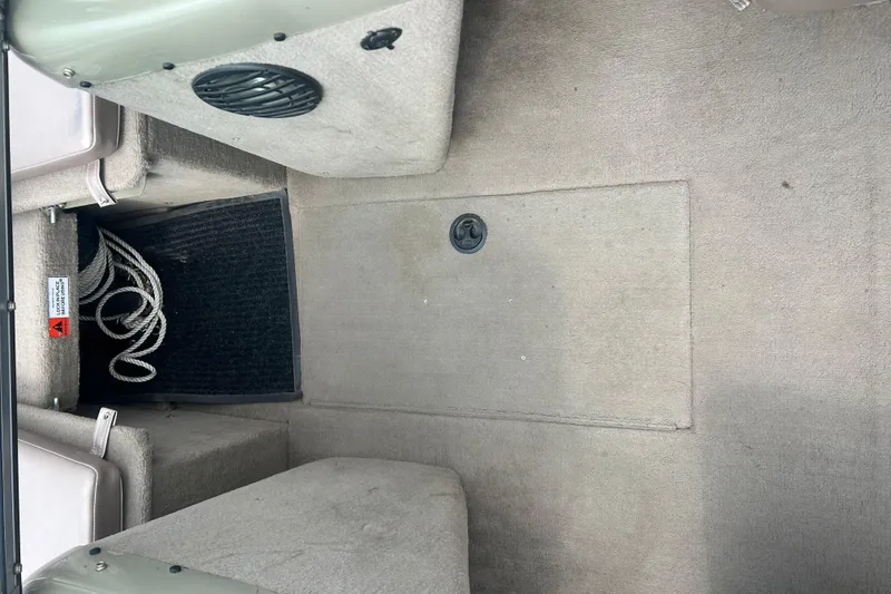 Slide: The Image of Interior of a 2006 Lowe Fish & Ski 175 boat, featuring carpeted flooring and storage compartments. - 20