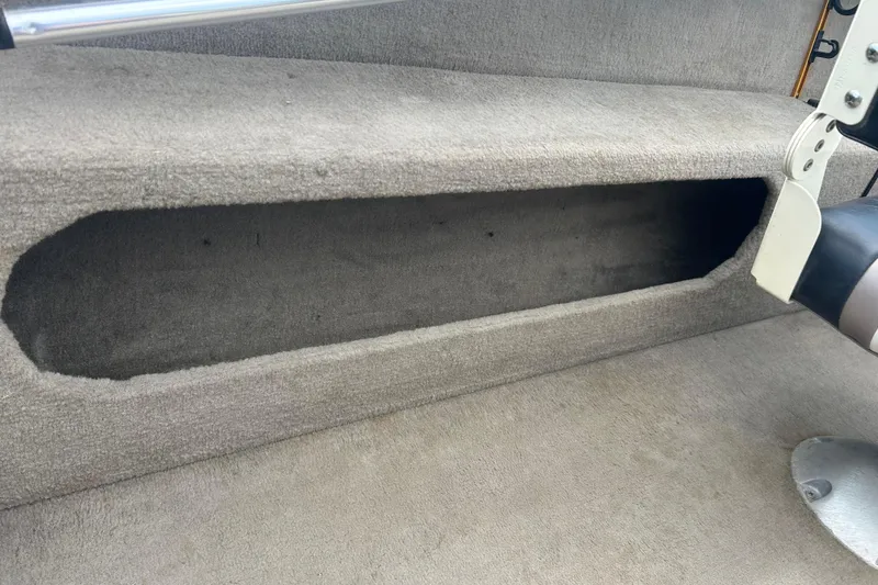 Slide: The Image of 2006 Lowe Fish & Ski 175 boat interior storage compartment with gray carpet. - 22