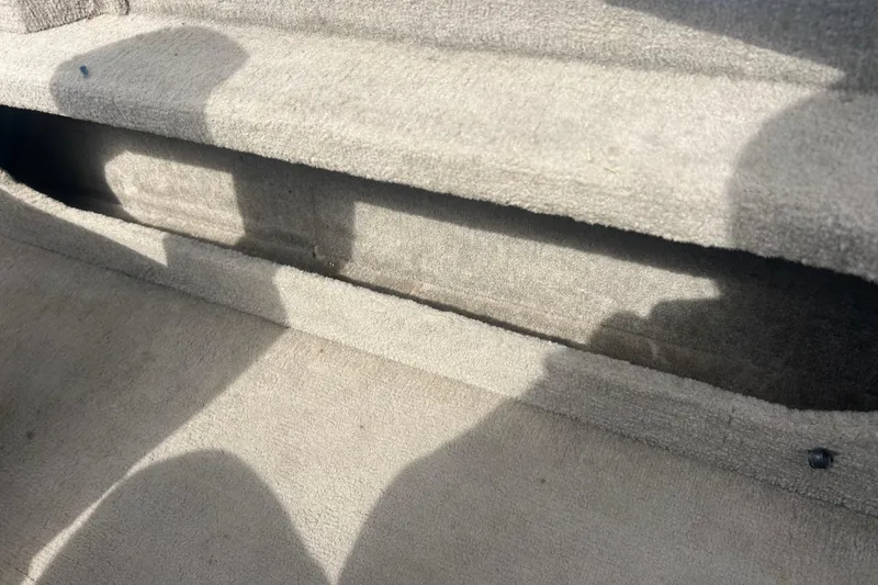 Slide: The Image of Carpeted interior of a 2006 Lowe Fish & Ski 175 boat, showing shadows. - 23