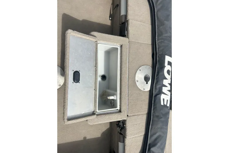 Slide: The Image of 2006 Lowe Fish & Ski 175 boat interior with open storage compartment. - 24