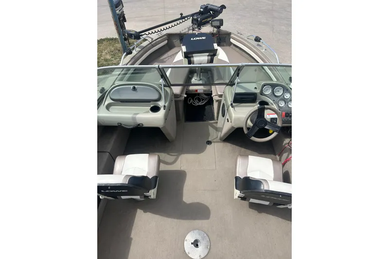 Slide: The Image of 2006 Lowe Fish & Ski 175 boat interior with steering wheel and seating. - 25