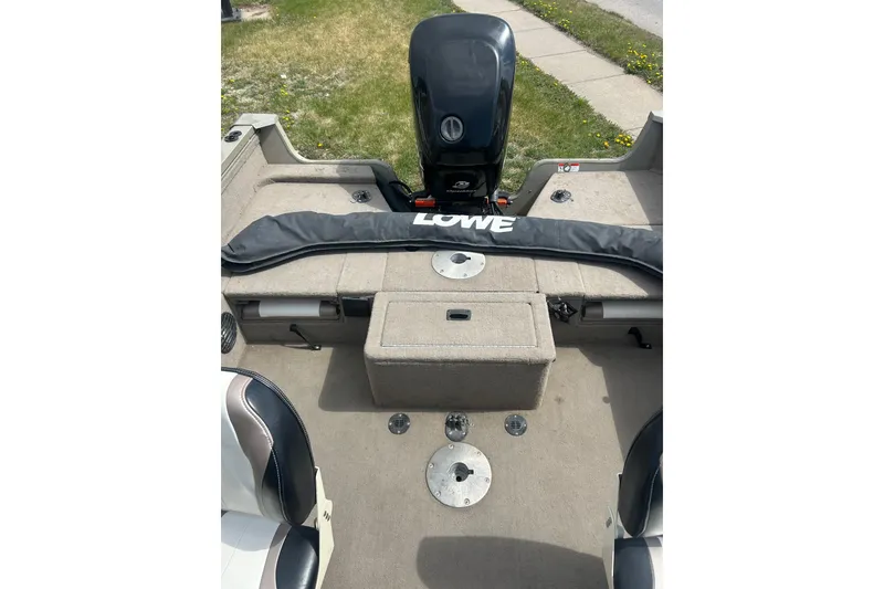 Slide: The Image of 2006 Lowe Fish & Ski 175 boat interior with motor and seating area. - 26