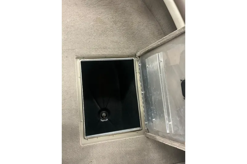 Slide: The Image of Open storage compartment on 2006 Lowe Fish & Ski 175 boat, showing interior details. - 32