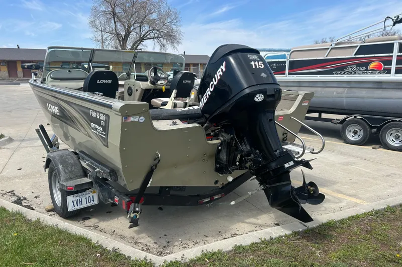 Slide: The Image of 2006 Lowe Fish & Ski 175 boat with Mercury 115 outboard motor in parking lot. - 4