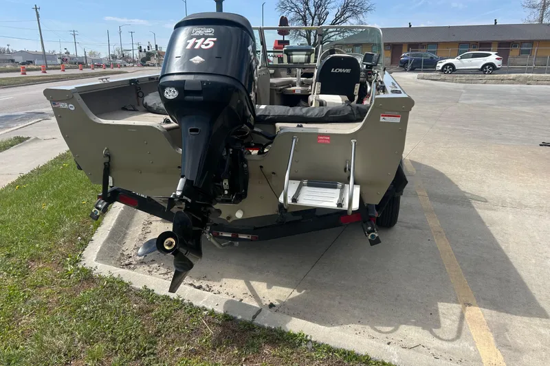 Slide: The Image of 2006 Lowe Fish & Ski 175 boat with outboard motor in parking lot. - 8