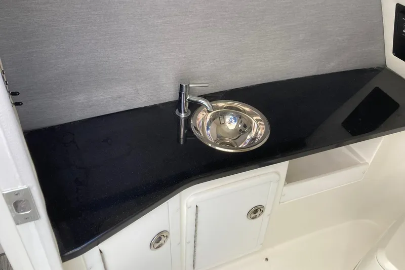 Slide: The Image of Compact sink and countertop in 2022 Cobalt R30 boat interior. - 14