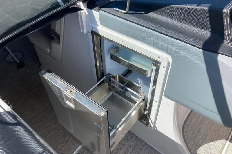 Slide: The Image of Open drawer on 2022 Cobalt R30 boat, showcasing interior storage space. - 18