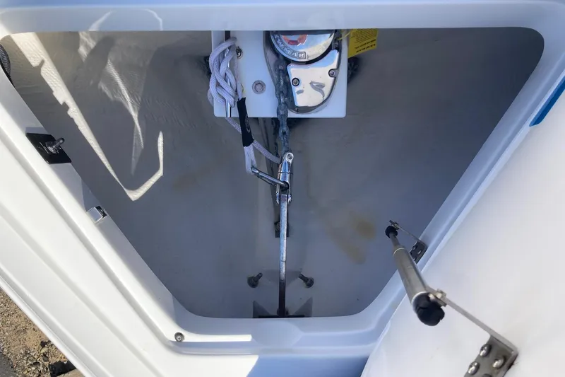 Slide: The Image of Anchor compartment of 2022 Cobalt R30 boat, featuring winch and rope storage. - 19