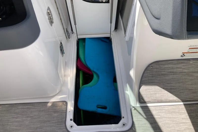 Slide: The Image of Storage compartment on 2022 Cobalt R30 boat with colorful life jackets inside. - 20